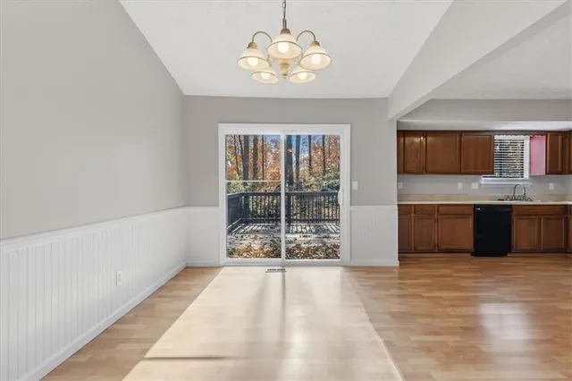 a view of kitchen with granite countertop cabinets and window