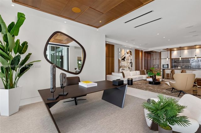a view of a living room with a flat screen tv and floor to ceiling window