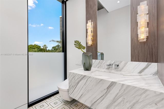 a bathroom with a granite countertop sink a toilet and shower