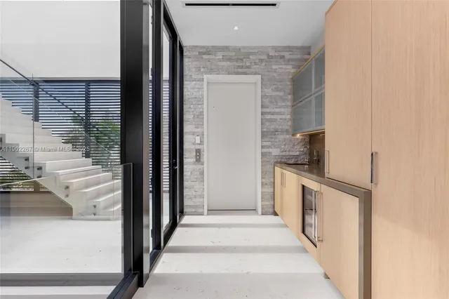 front view of a house with a yard and potted plants