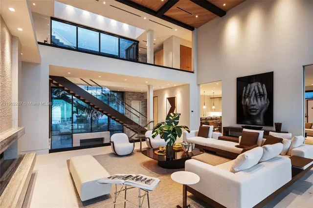 a room with stainless steel appliances kitchen island granite countertop a table and chairs in it