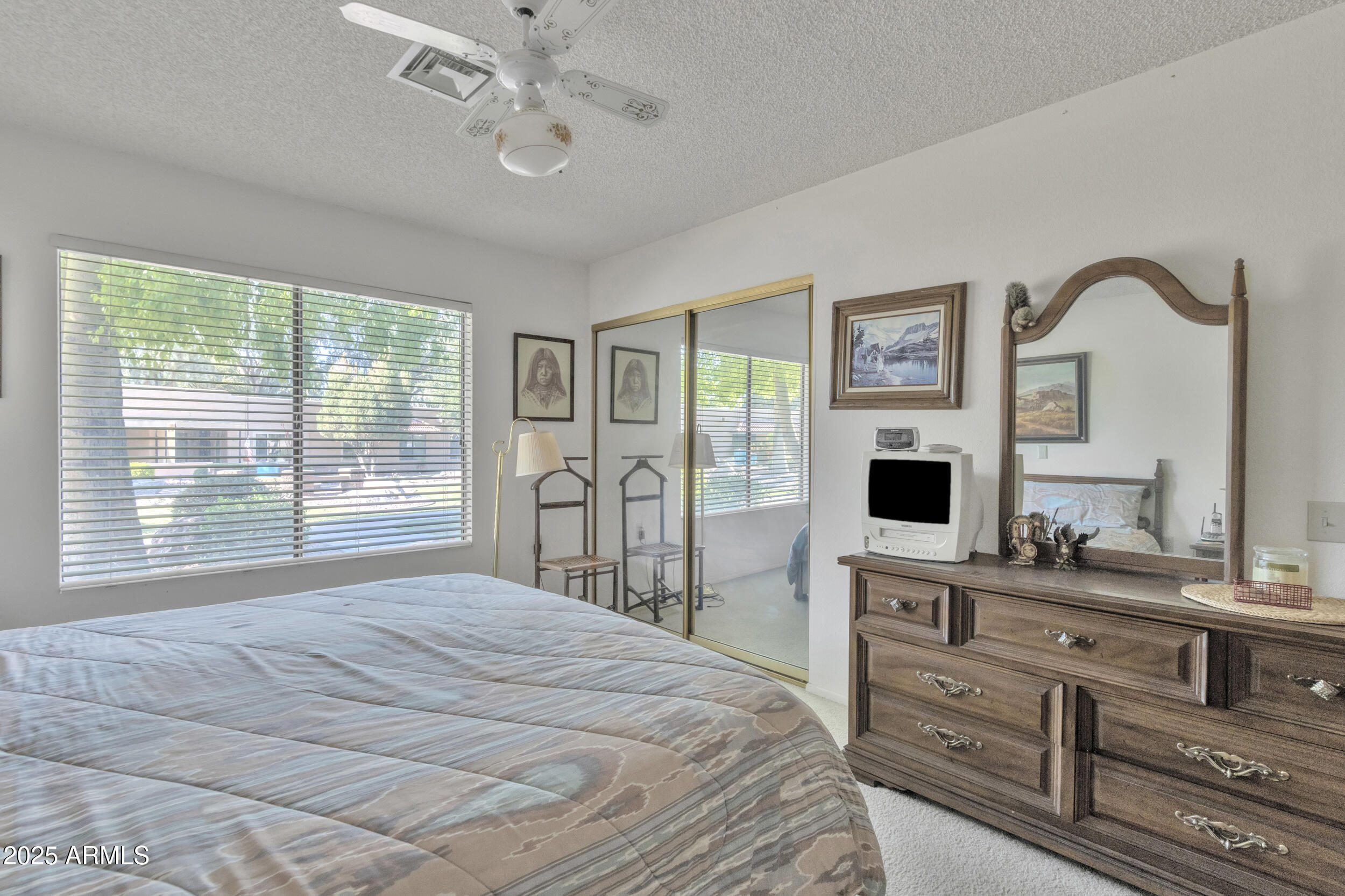 14300 West Bell Road, Unit 105 Surprise, AZ 85374 - Photo 15 of 45 a bedroom with a bed and a flat screen tv