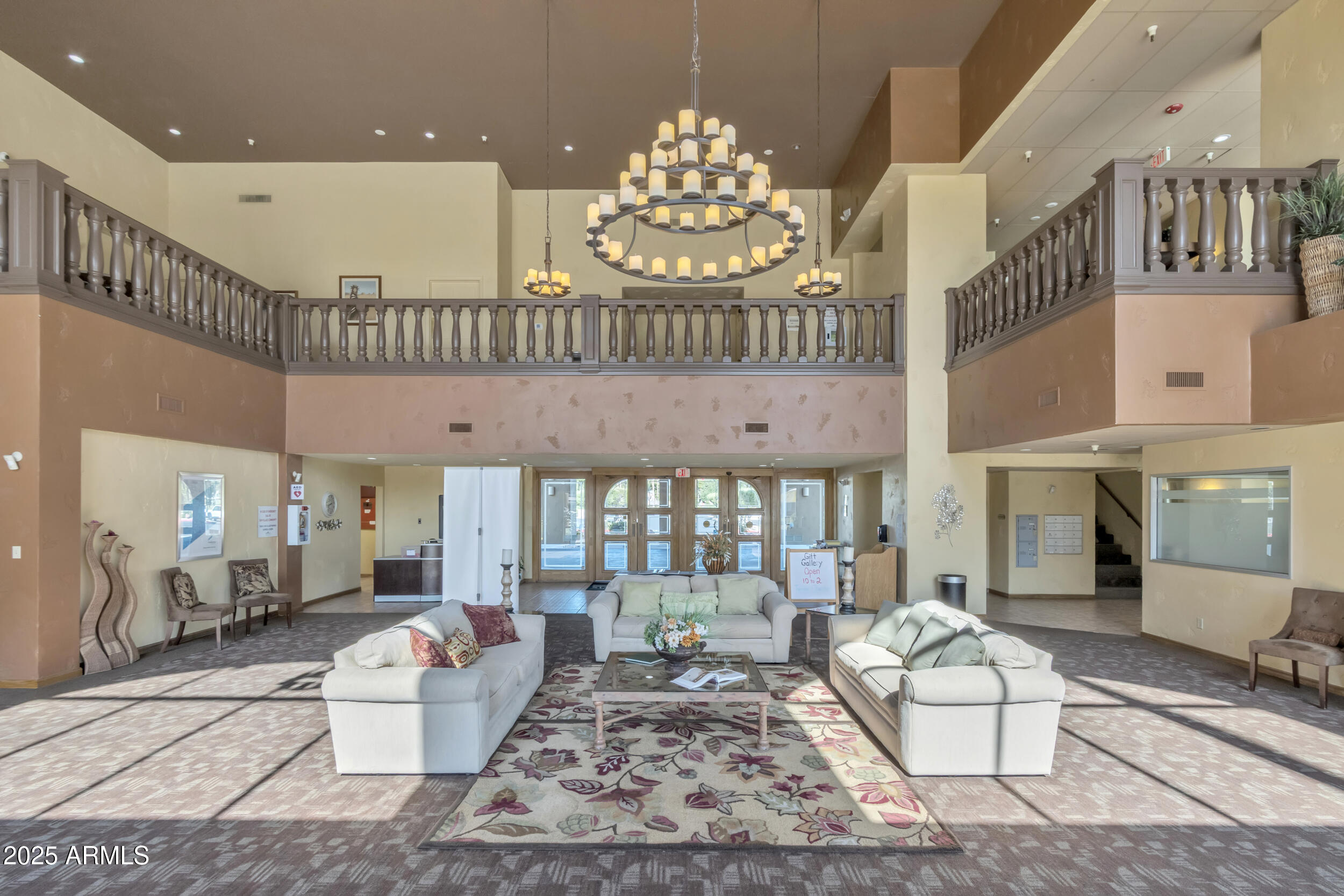 14300 West Bell Road, Unit 105 Surprise, AZ 85374 - Photo 31 of 45 a living room with furniture chandelier and a rug