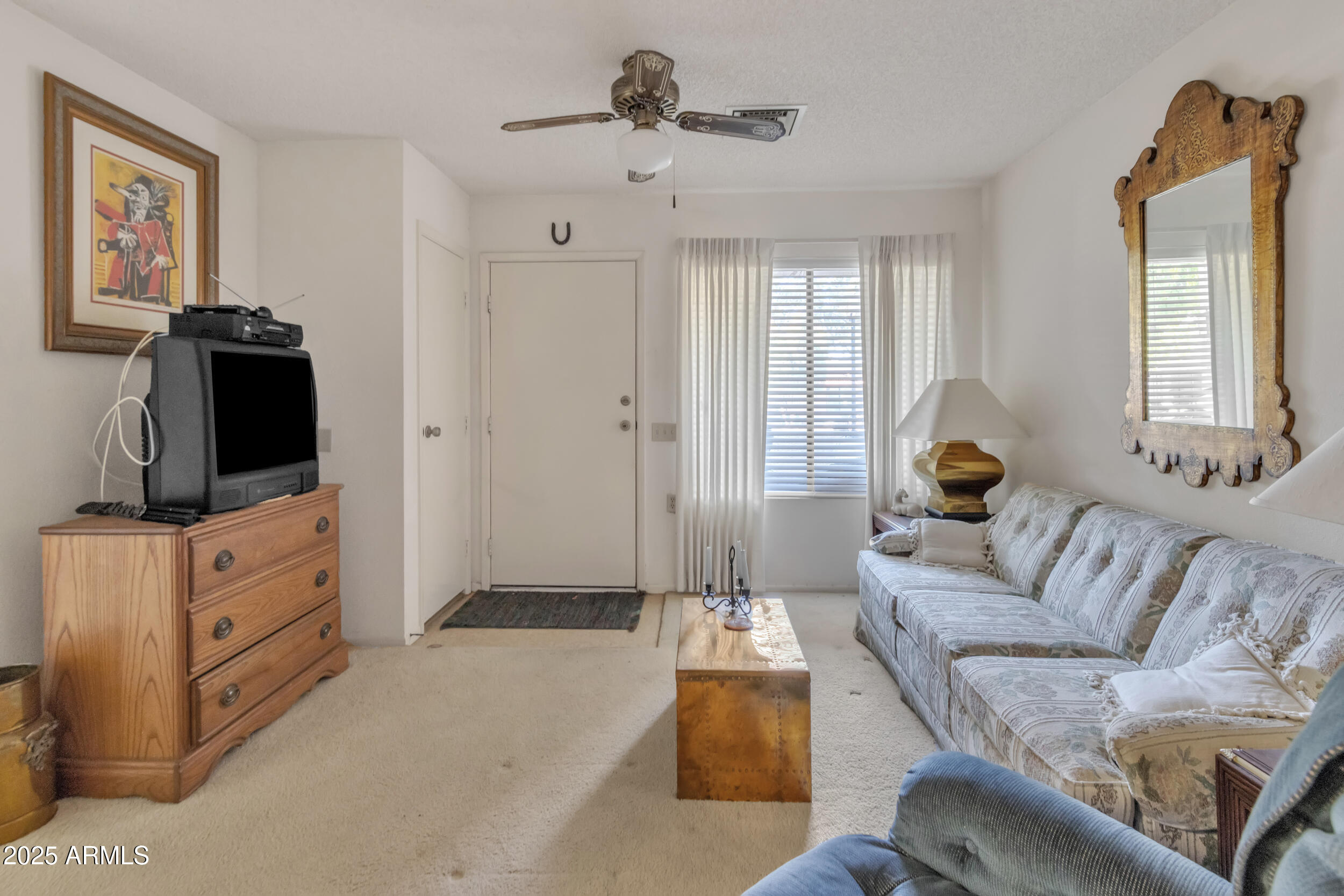 14300 West Bell Road, Unit 105 Surprise, AZ 85374 - Photo 3 of 45 a living room with furniture and a flat screen tv