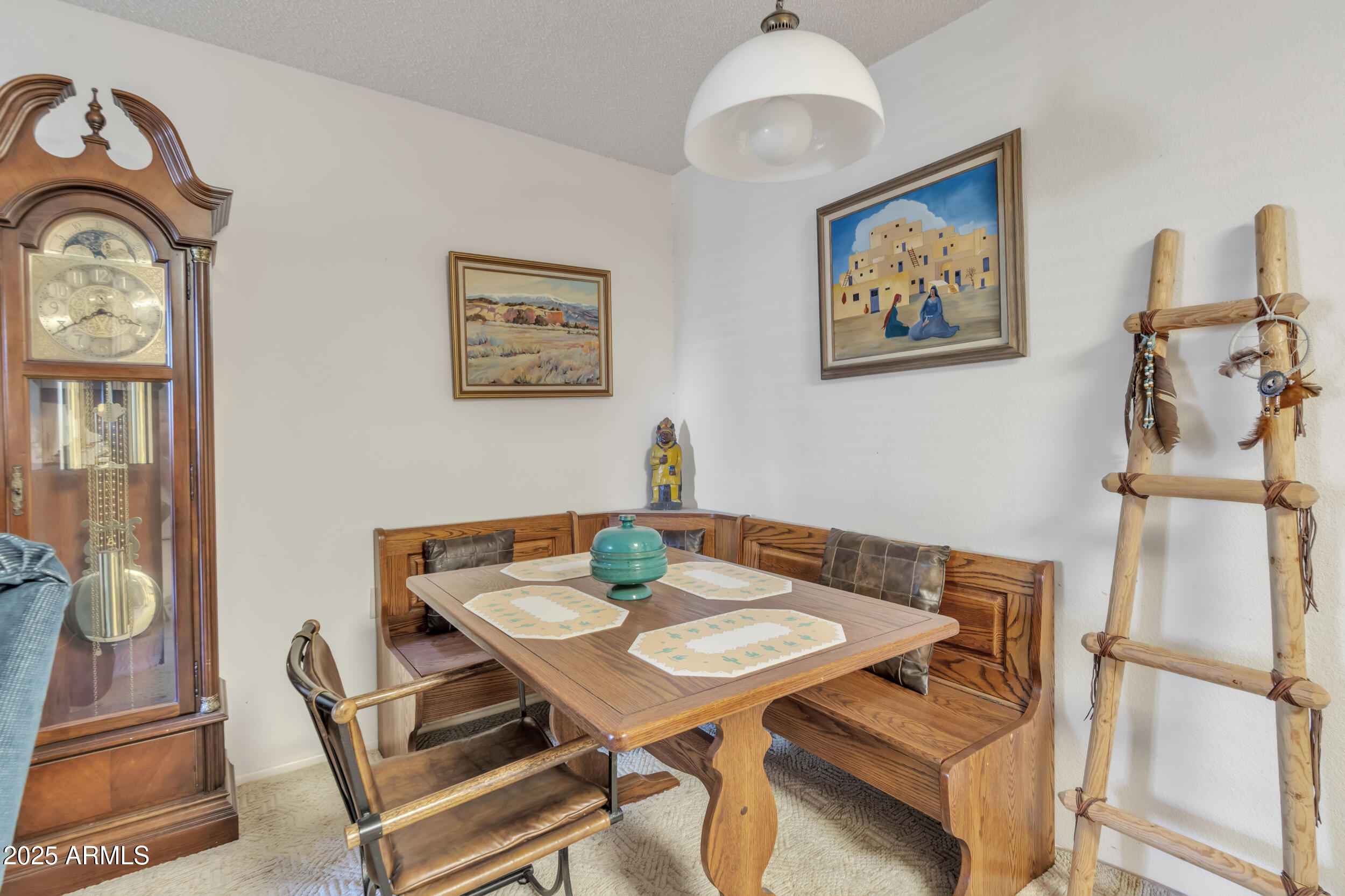 14300 West Bell Road, Unit 105 Surprise, AZ 85374 - Photo 6 of 45 a view of a dining room with furniture and a chandelier