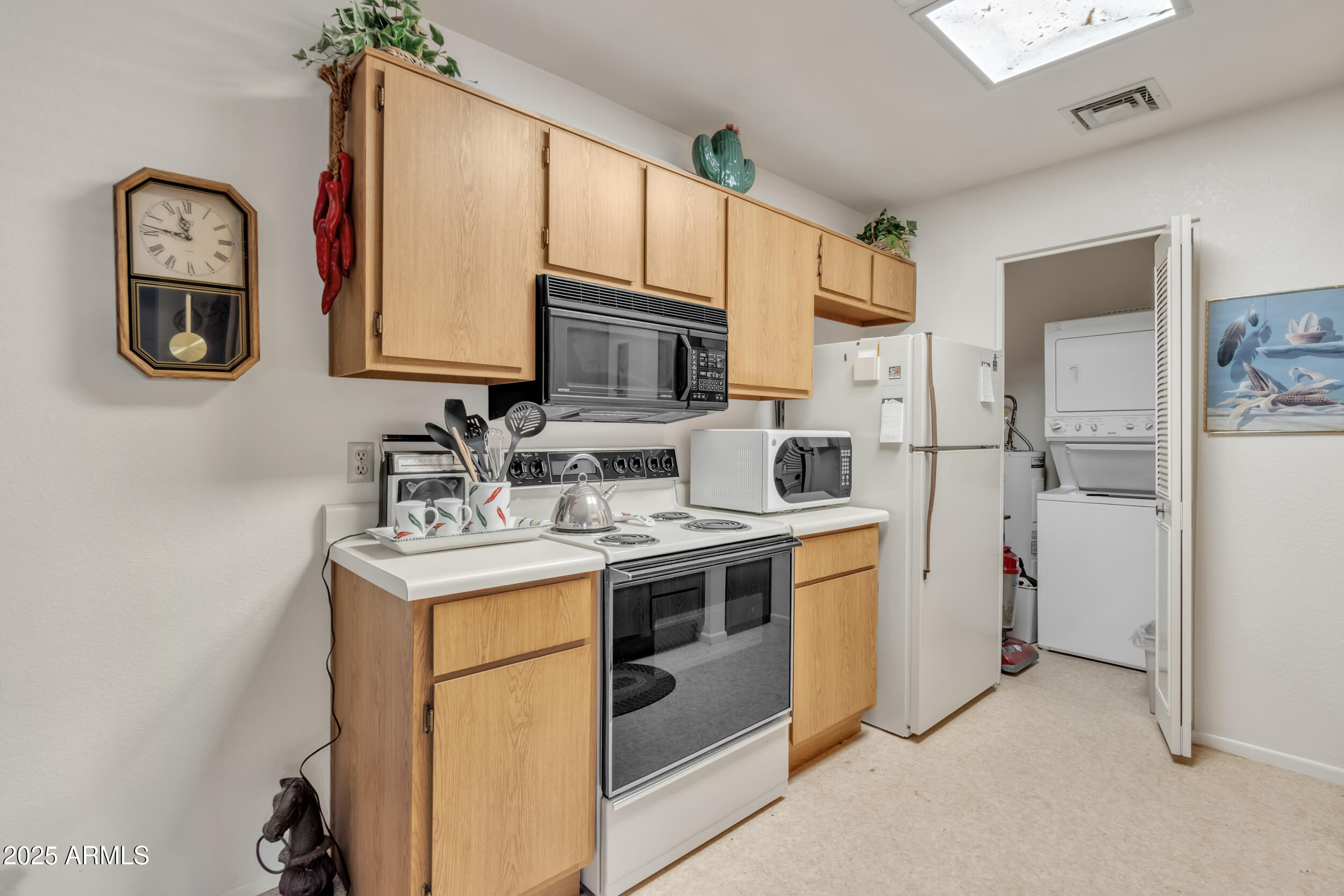 14300 West Bell Road, Unit 105 Surprise, AZ 85374 - Photo 9 of 45 a kitchen with stainless steel appliances granite countertop a sink stove refrigerator and cabinets