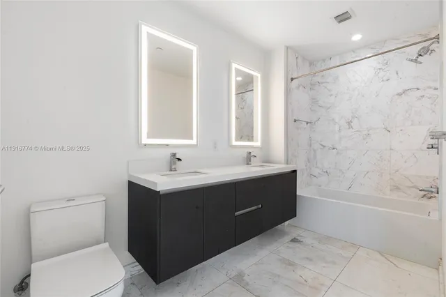 a bedroom with a bed and glass windows