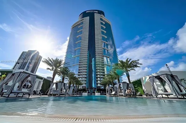 a view of a swimming pool with outdoor seating