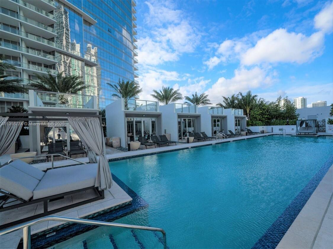851 Northeast 1st Avenue, Unit 3202 Miami, FL 33132 - Photo 50 of 68 a view of a swimming pool with lounge chairs