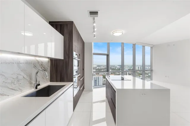 a very nice looking room with a large window and furniture