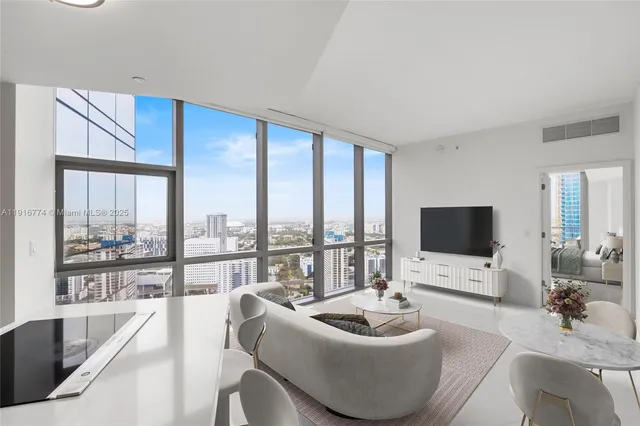 a living room with furniture and a large window
