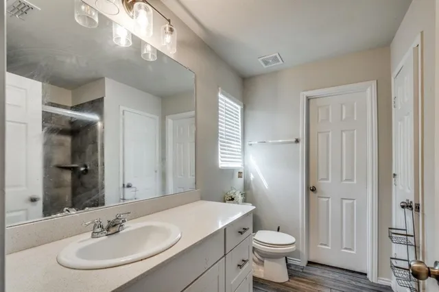 a bathroom with a sink toilet and a mirror
