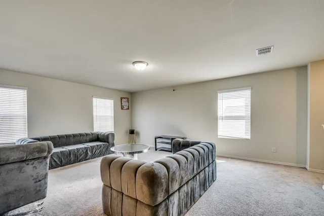 a spacious bedroom with a bed and a couch