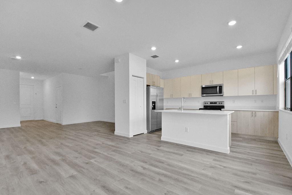 4083 Sunset Way Pompano Beach, FL 33069 - Photo 18 of 34 a view of kitchen with granite countertop stainless steel appliances refrigerator and microwave