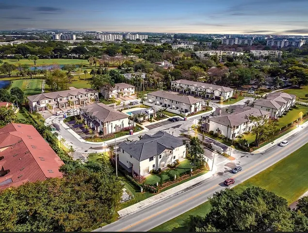an aerial view of residential houses with outdoor space
