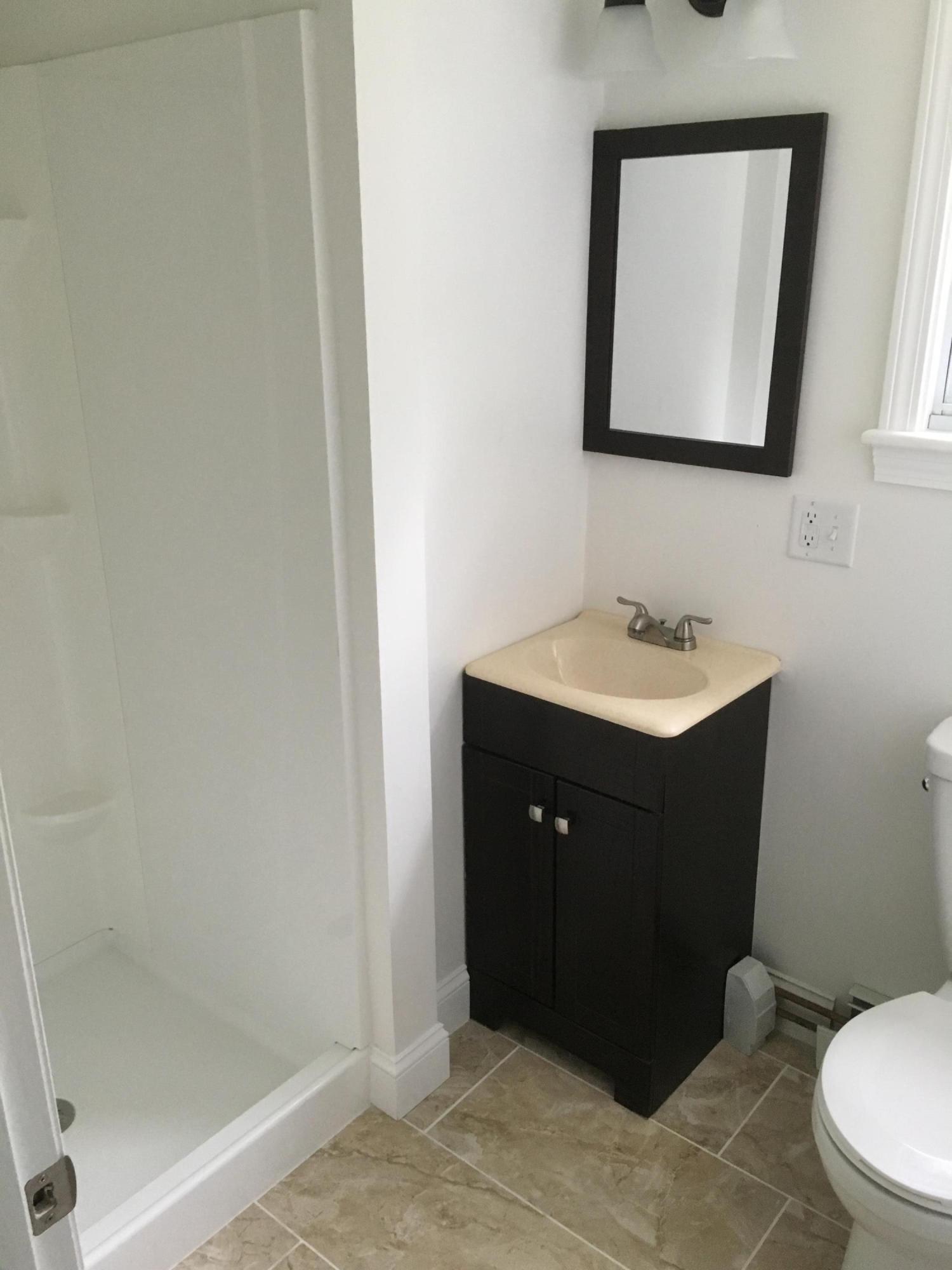 18 Seawood Road Wareham, MA 02571 - Photo 11 of 13 a bathroom with a sink vanity mirror and toilet