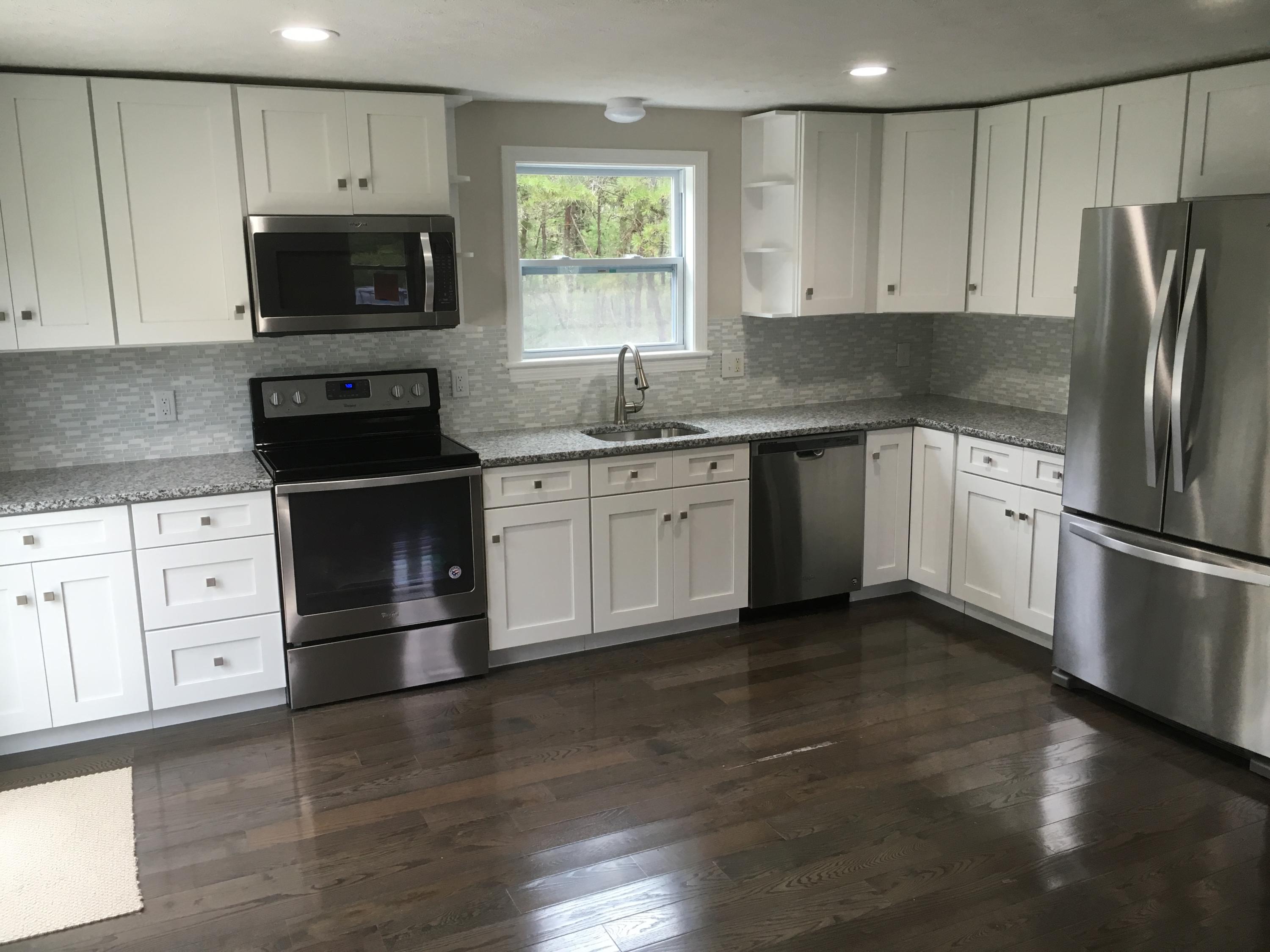 18 Seawood Road Wareham, MA 02571 - Photo 3 of 13 a kitchen with granite countertop a refrigerator stove and microwave