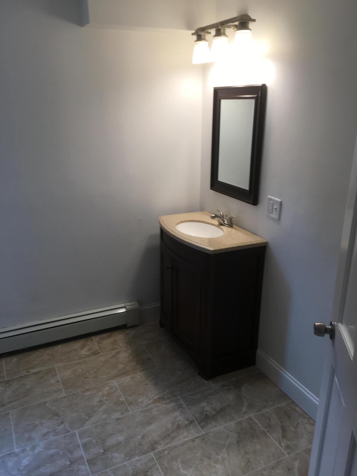 18 Seawood Road Wareham, MA 02571 - Photo 6 of 13 a bathroom with a sink and a mirror