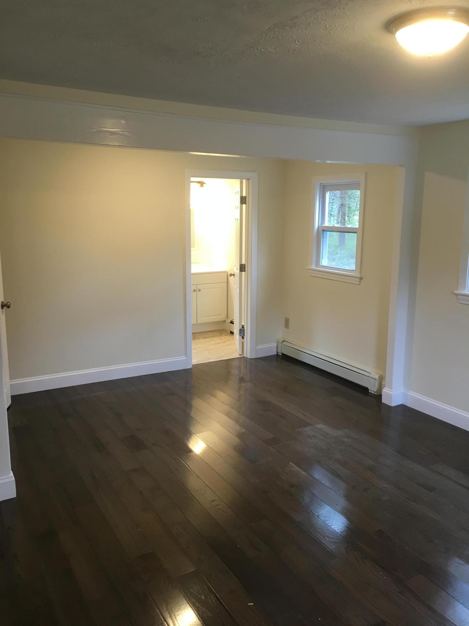 18 Seawood Road Wareham, MA 02571 - Photo 9 of 13 a view of empty room with wooden floor and fan