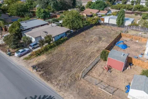 an aerial view of a house with a yard basket ball court and outdoor seating