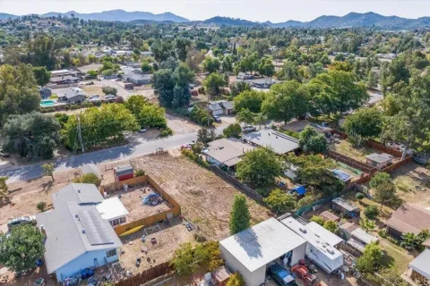 an aerial view of residential house with green space