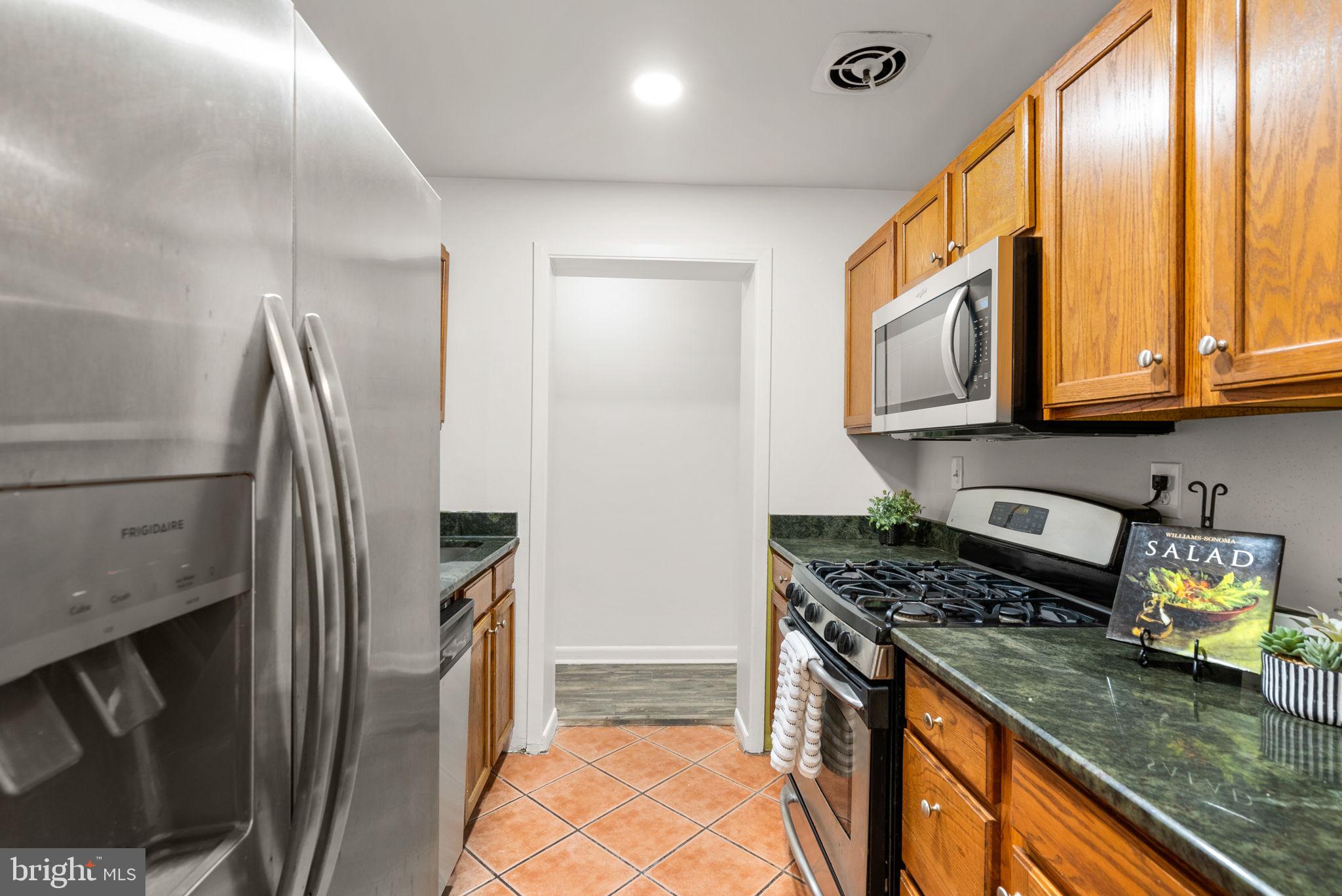 199 Talbott Street, Unit 199 Rockville, MD 20852 - Photo 11 of 31 a kitchen with stainless steel appliances granite countertop a refrigerator a stove and a sink