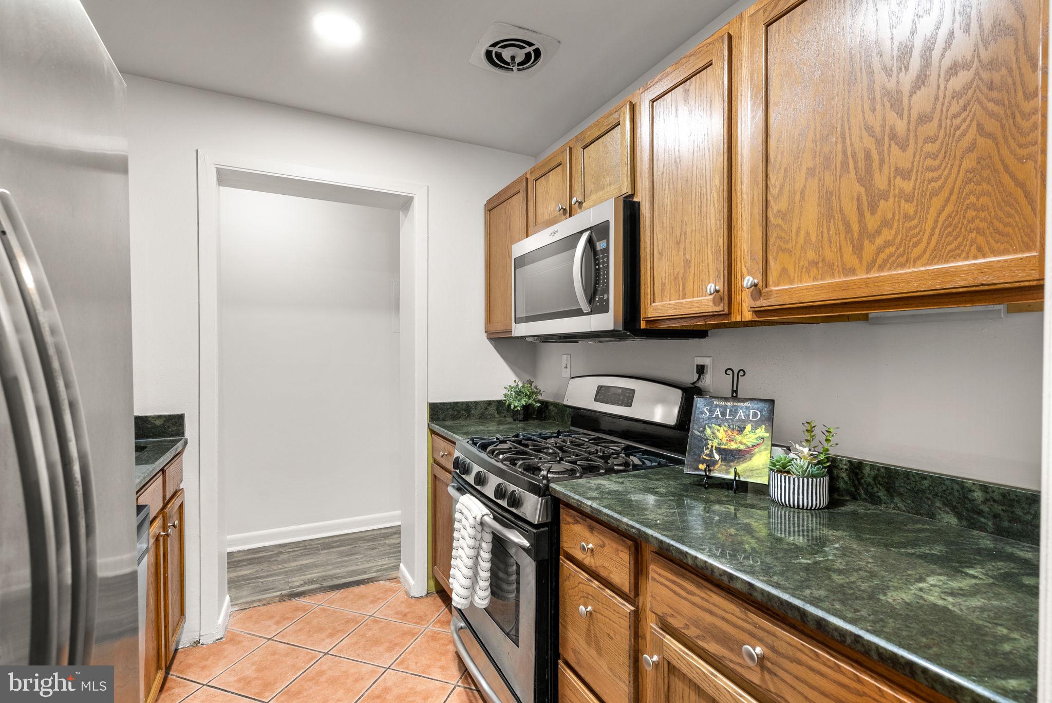 199 Talbott Street, Unit 199 Rockville, MD 20852 - Photo 12 of 31 a kitchen with stainless steel appliances granite countertop a refrigerator a stove and a sink