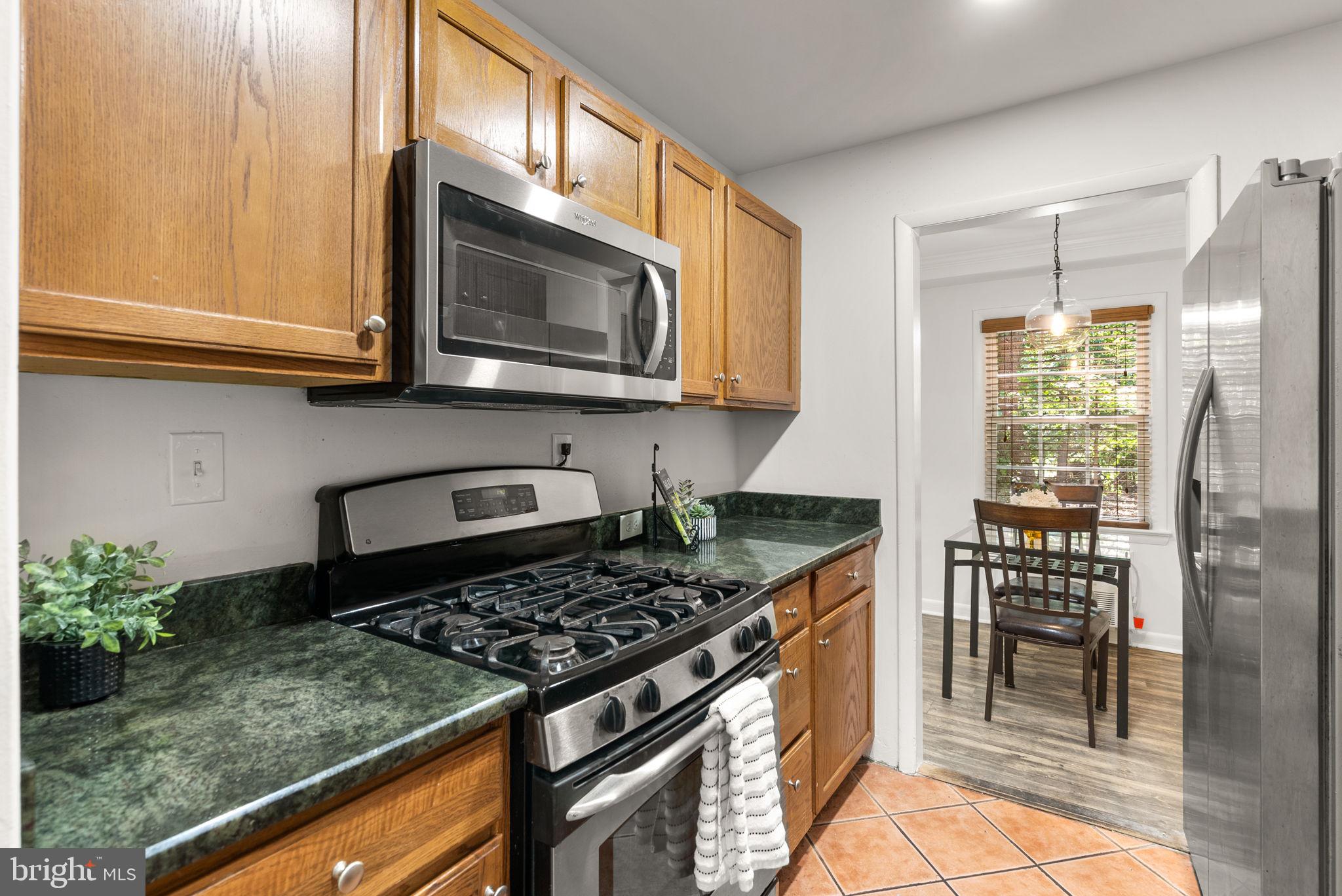 199 Talbott Street, Unit 199 Rockville, MD 20852 - Photo 13 of 31 a kitchen with a stove a microwave and cabinets