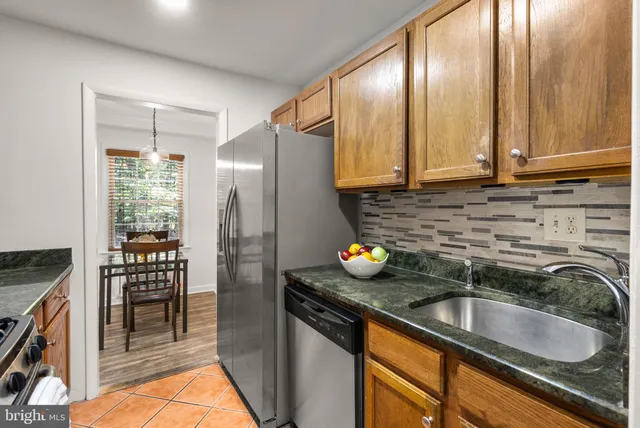 a kitchen with a sink cabinets and stainless steel appliances