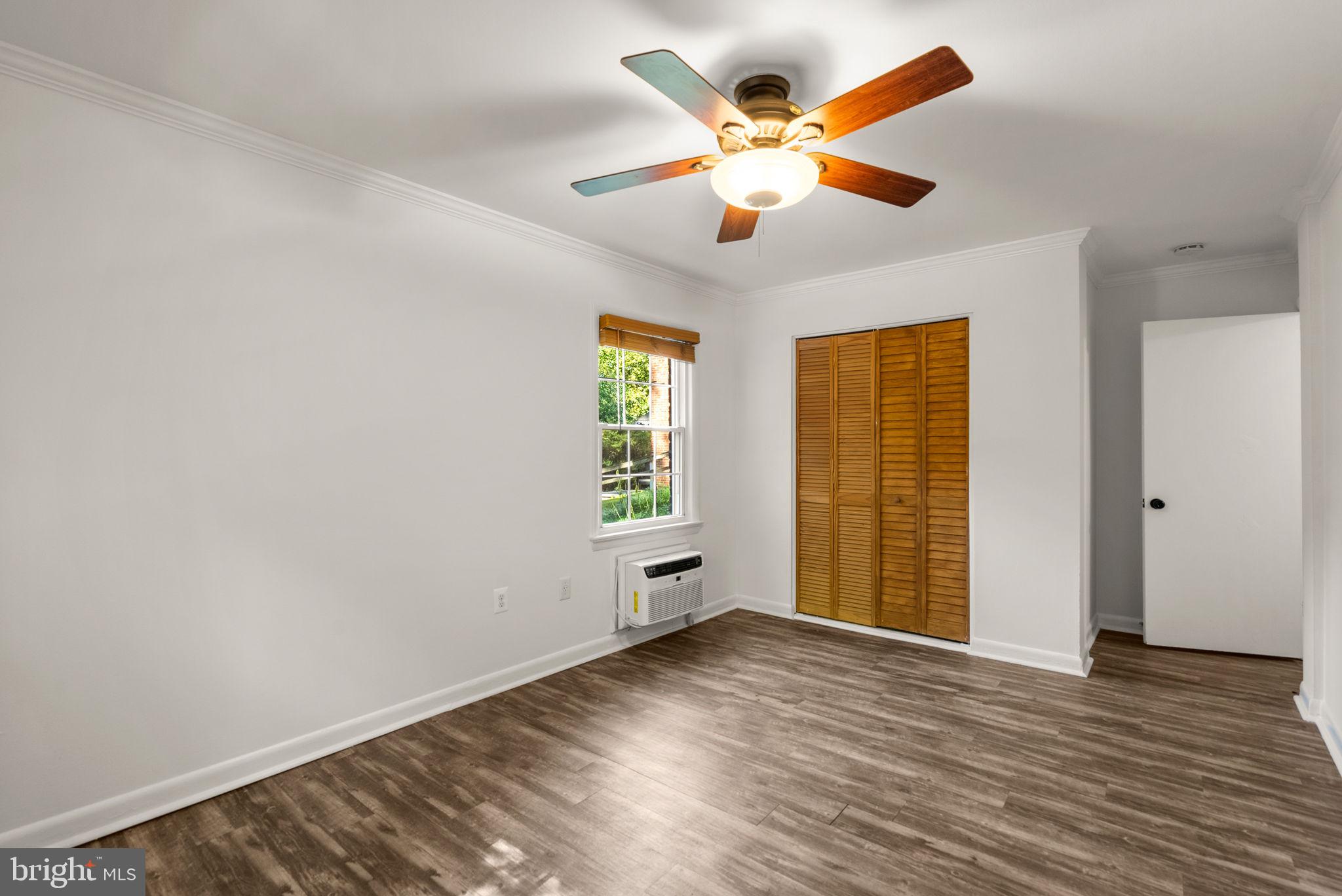199 Talbott Street, Unit 199 Rockville, MD 20852 - Photo 17 of 31 an empty room with wooden floor and windows