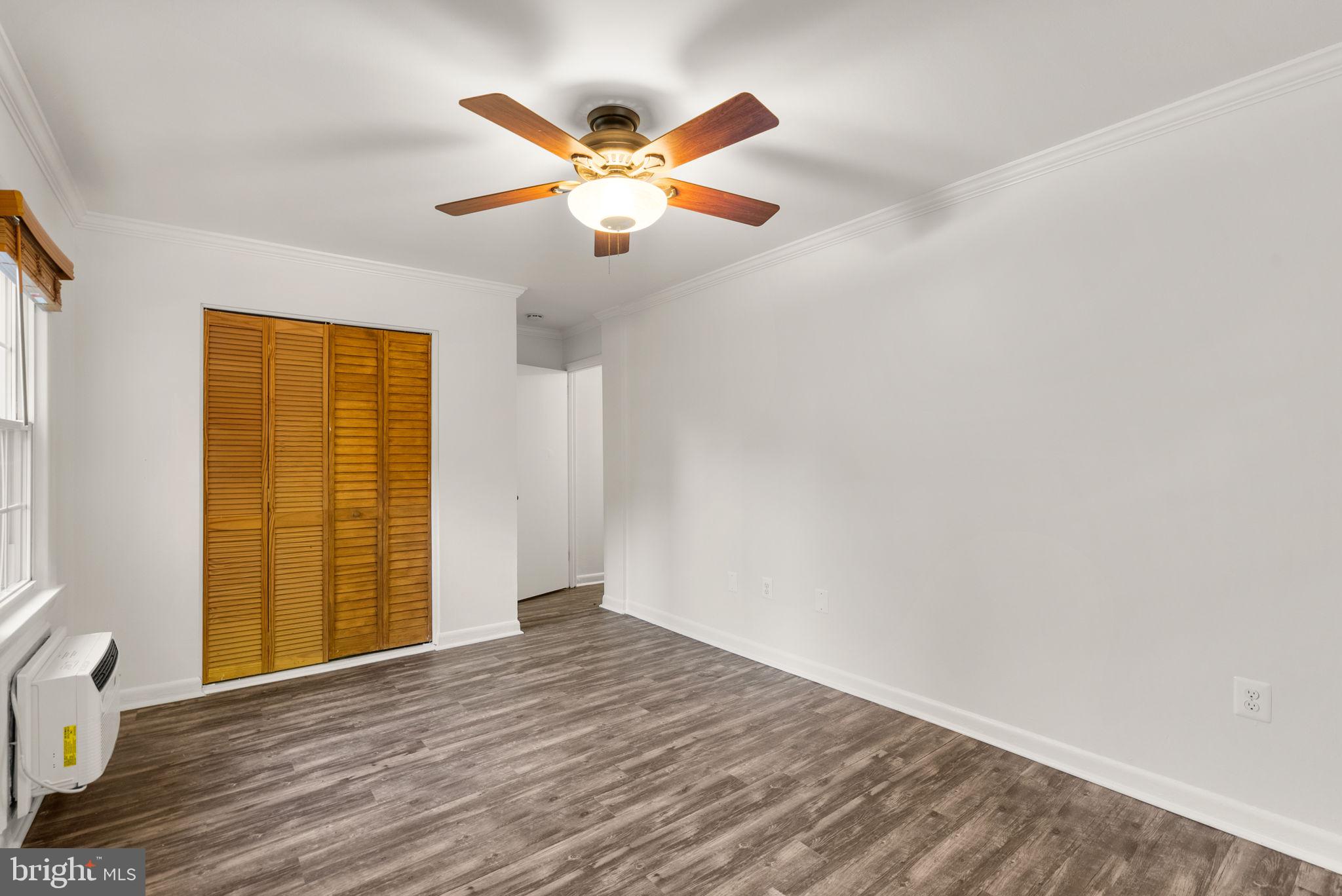 199 Talbott Street, Unit 199 Rockville, MD 20852 - Photo 18 of 31 a view of an empty room with wooden floor and a window