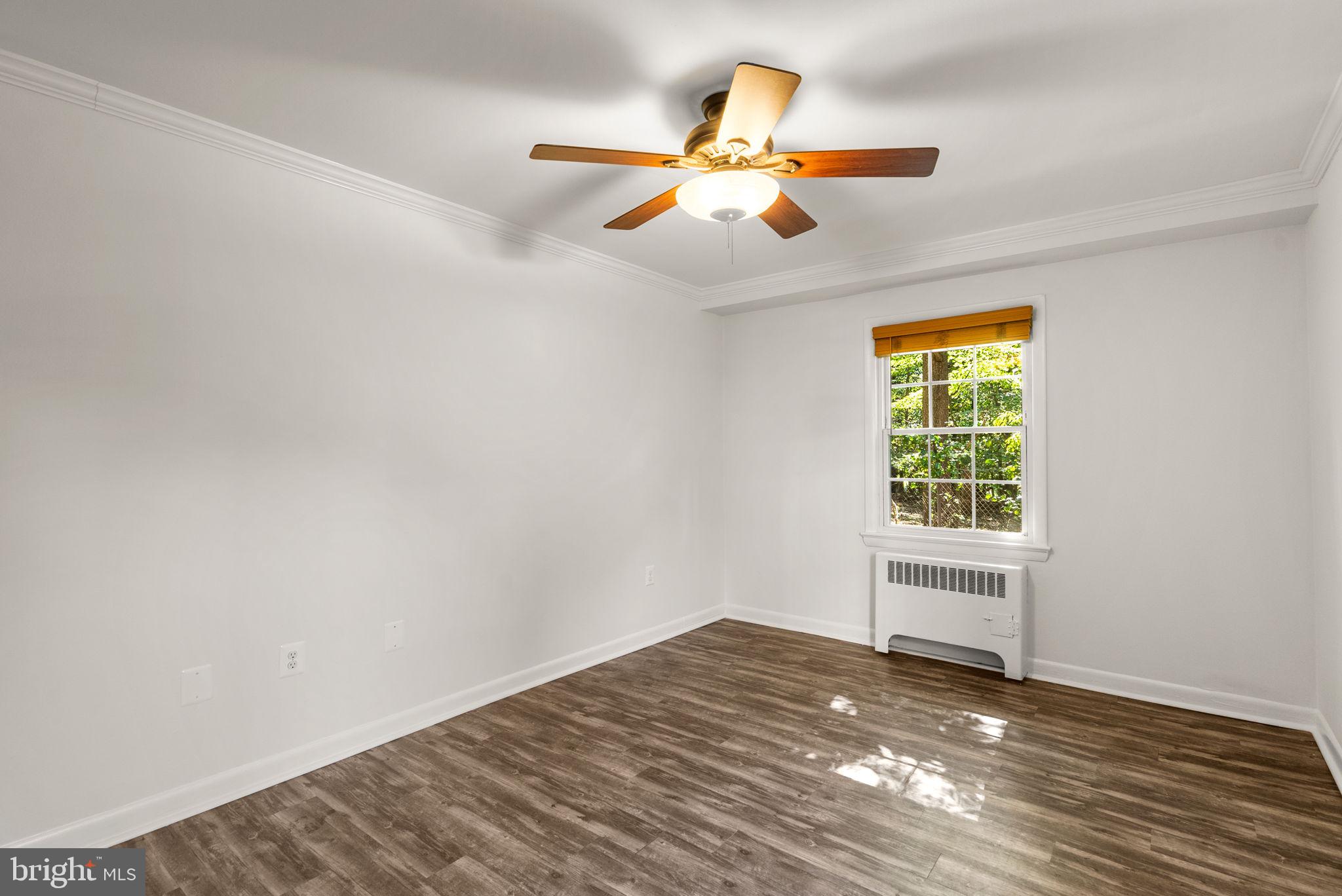 199 Talbott Street, Unit 199 Rockville, MD 20852 - Photo 19 of 31 wooden floor in an empty room with a window