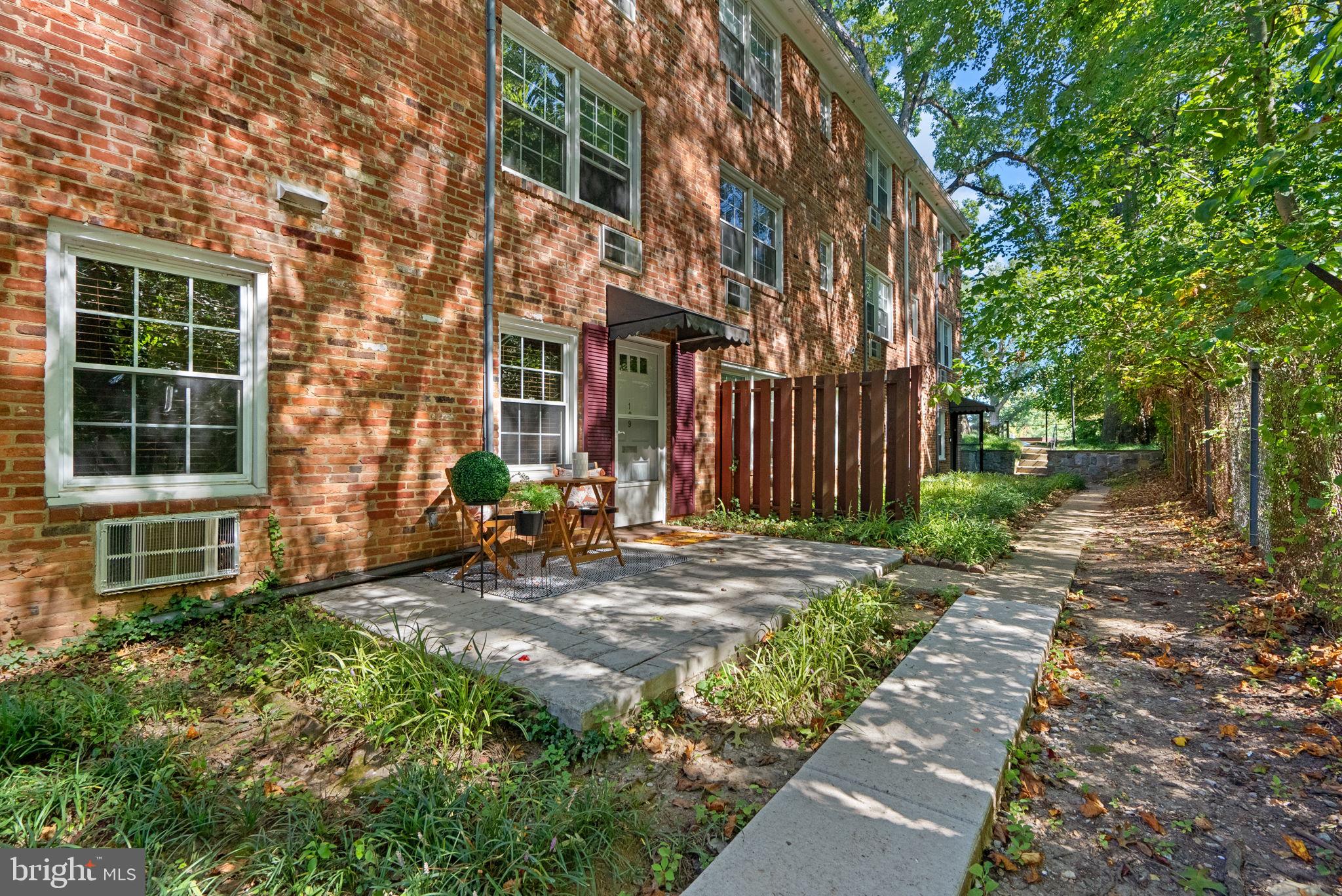 199 Talbott Street, Unit 199 Rockville, MD 20852 - Photo 31 of 31 a view of a brick house with many windows plants and large tree