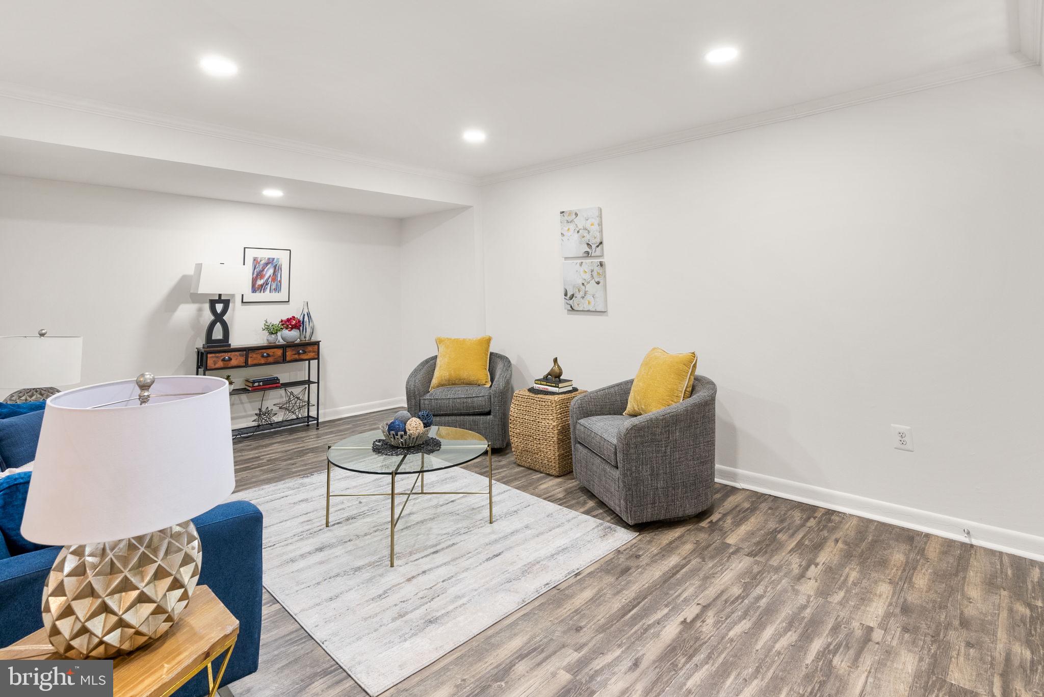 199 Talbott Street, Unit 199 Rockville, MD 20852 - Photo 5 of 31 a living room with furniture and a wooden floor