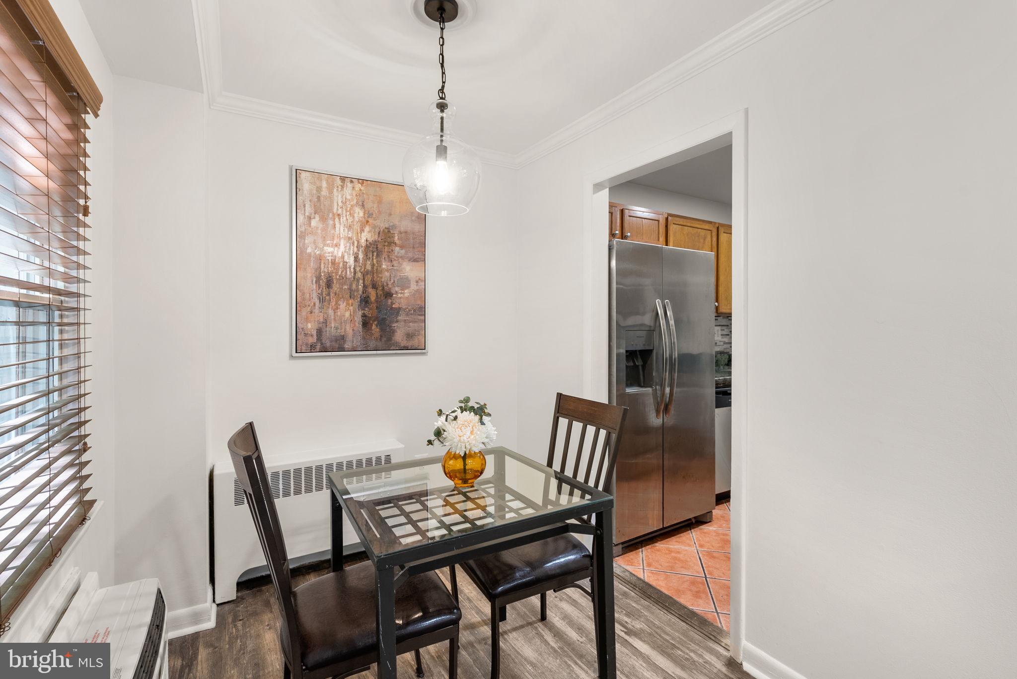 199 Talbott Street, Unit 199 Rockville, MD 20852 - Photo 9 of 31 a view of a dining room with furniture and wooden floor