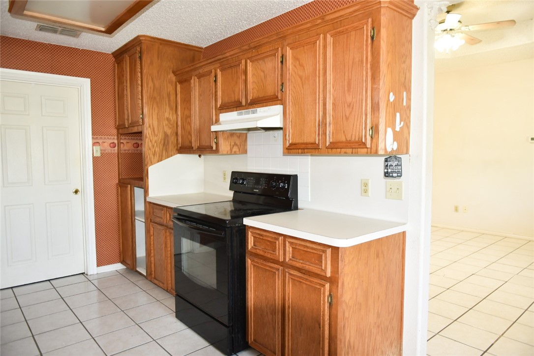 305 Hickory Bishop, TX 78343 - Photo 14 of 23 a kitchen with a sink stove and cabinets