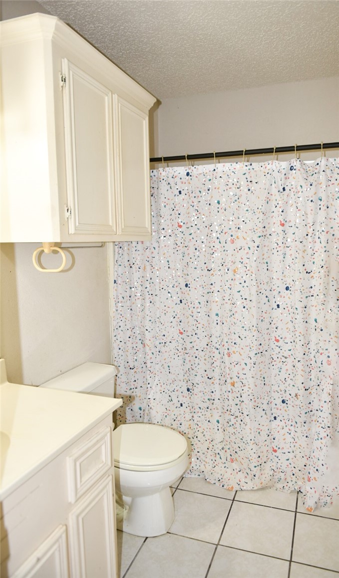 305 Hickory Bishop, TX 78343 - Photo 21 of 23 a bathroom with a toilet and a shower curtain