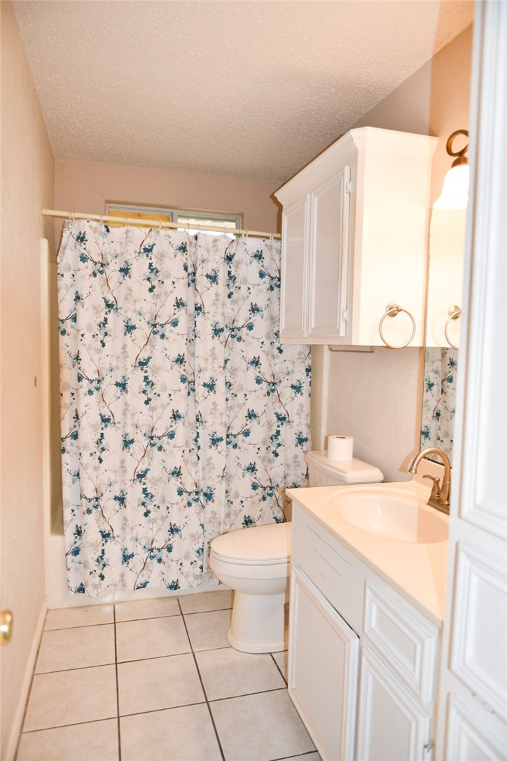305 Hickory Bishop, TX 78343 - Photo 23 of 23 a bathroom with a sink toilet and shower