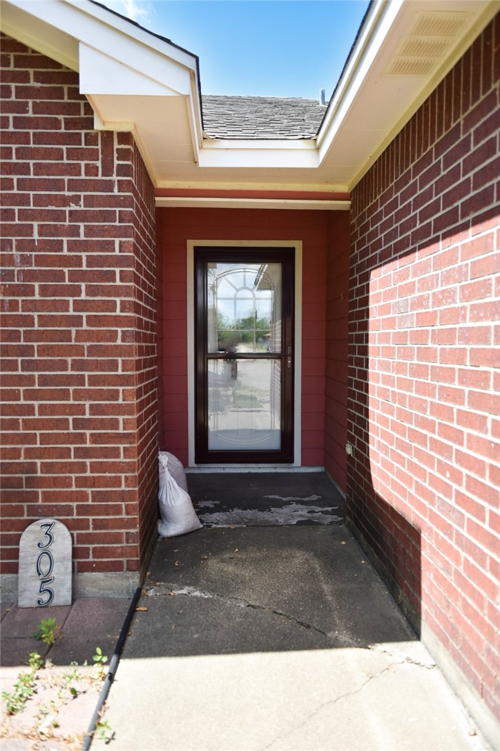 305 Hickory Bishop, TX 78343 - Photo 4 of 23 a black and white photo of a fireplace