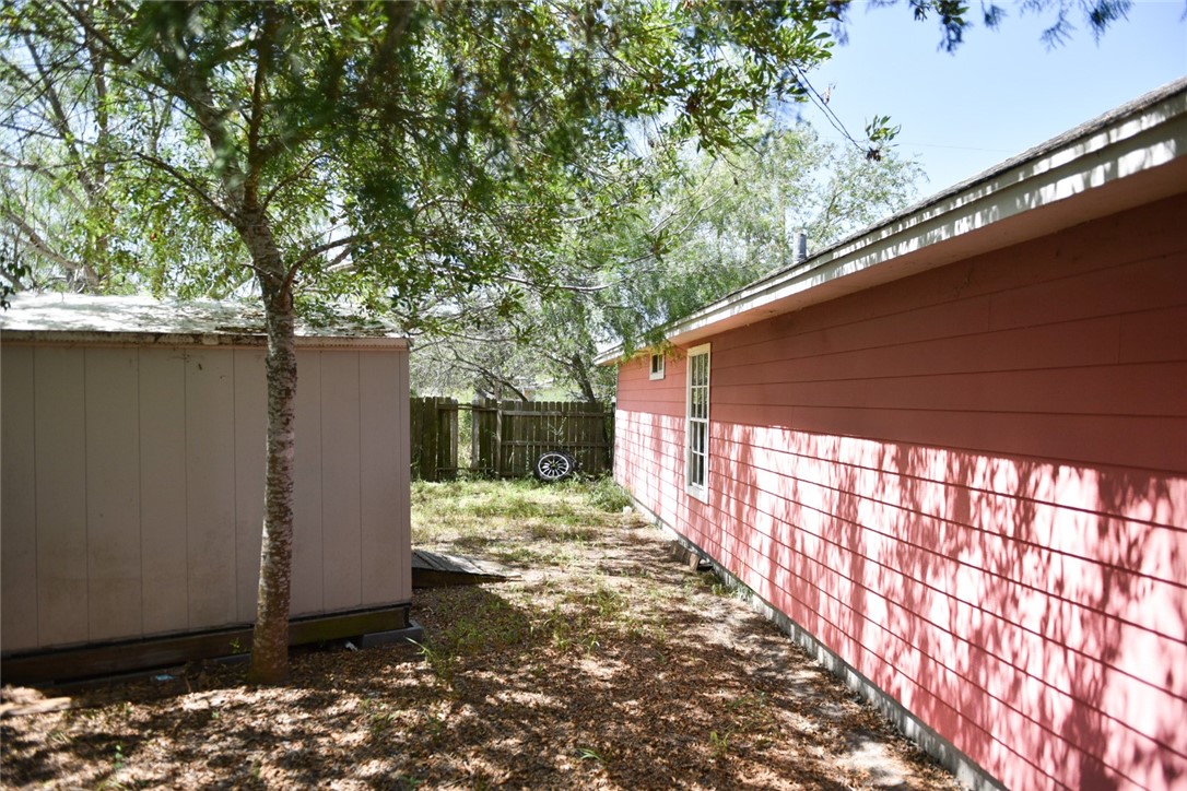 305 Hickory Bishop, TX 78343 - Photo 5 of 23 a view of backyard with large trees and wooden fence