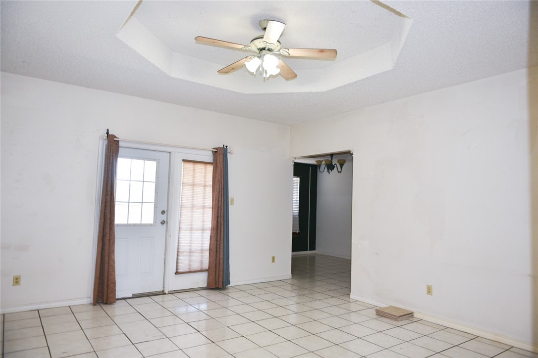 305 Hickory Bishop, TX 78343 - Photo 10 of 23 wooden floor in an empty room with a window