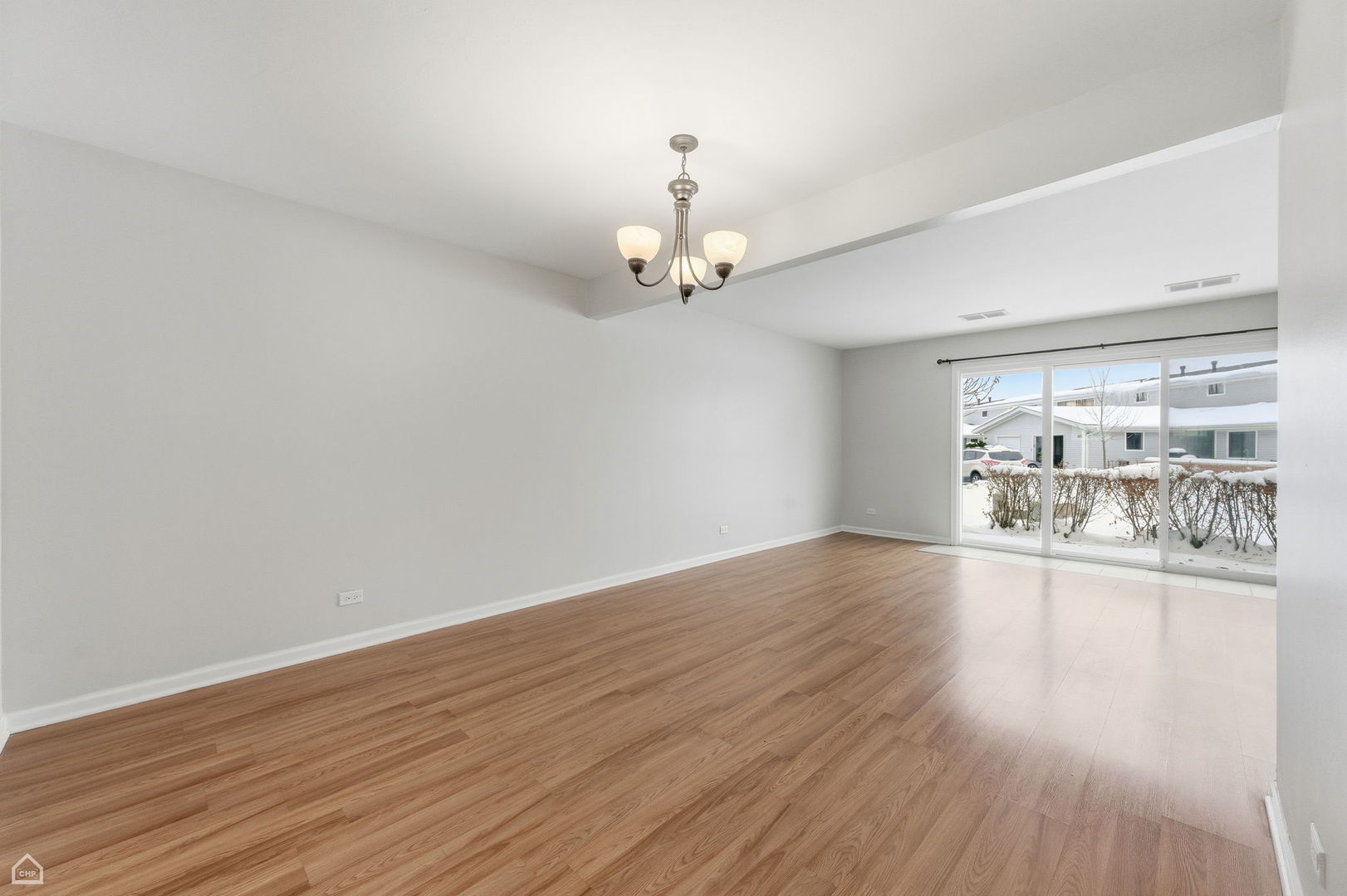 1081 Pinehurst Lane Schaumburg, IL 60193 - Photo 6 of 26 wooden floor in an empty room with a window