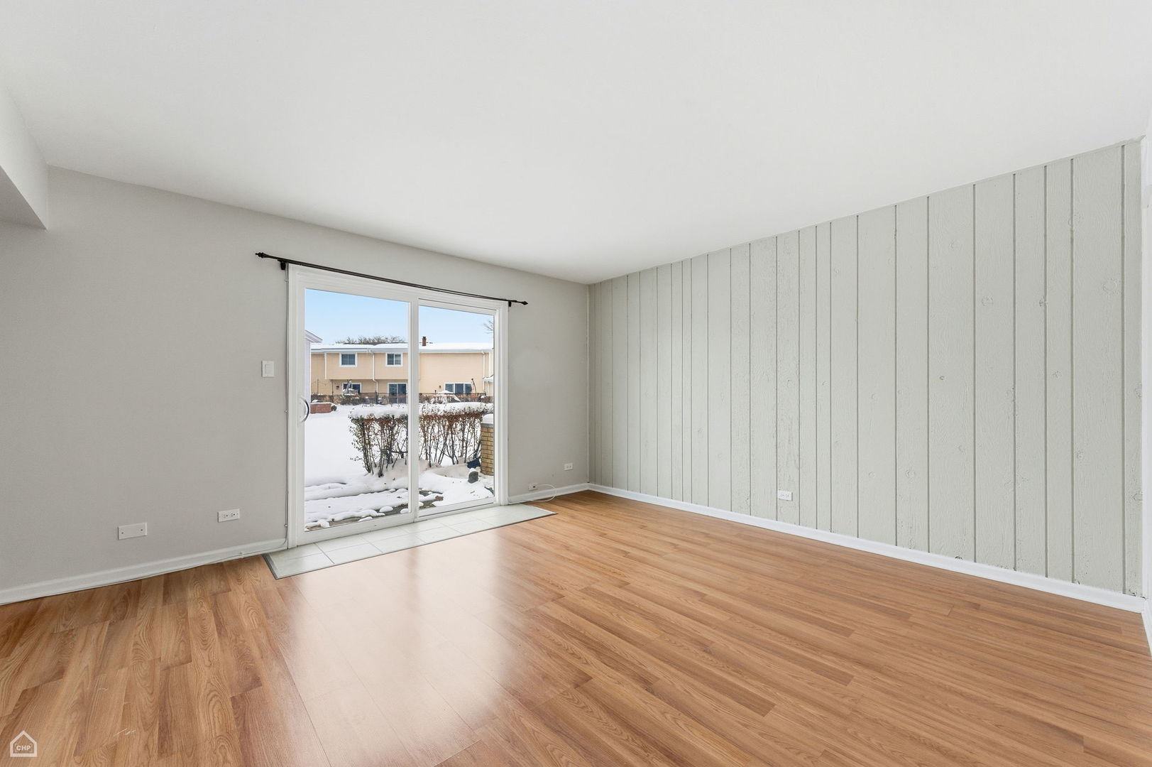 1081 Pinehurst Lane Schaumburg, IL 60193 - Photo 10 of 26 a view of an empty room with wooden floor and a window