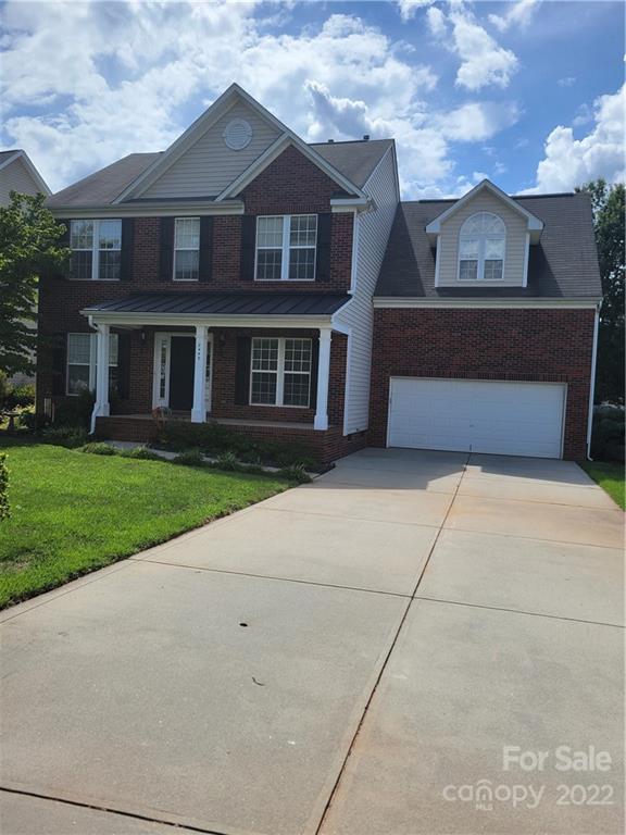 2449 Smith Cove Road Denver, NC 28037 - Photo 2 of 18 a front view of a house with a yard and a garage