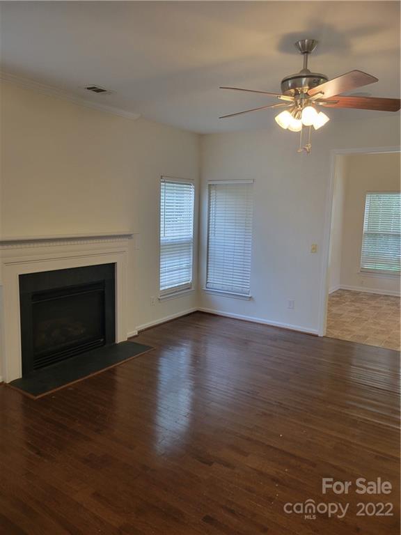 2449 Smith Cove Road Denver, NC 28037 - Photo 5 of 18 a view of a livingroom with a fireplace wooden floor and chandelier
