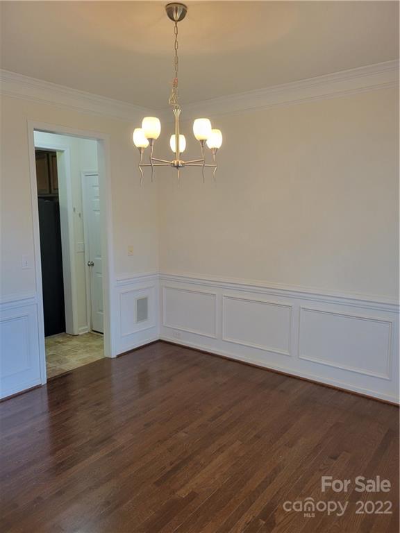 2449 Smith Cove Road Denver, NC 28037 - Photo 7 of 18 a view of a chandelier fan and wooden floor