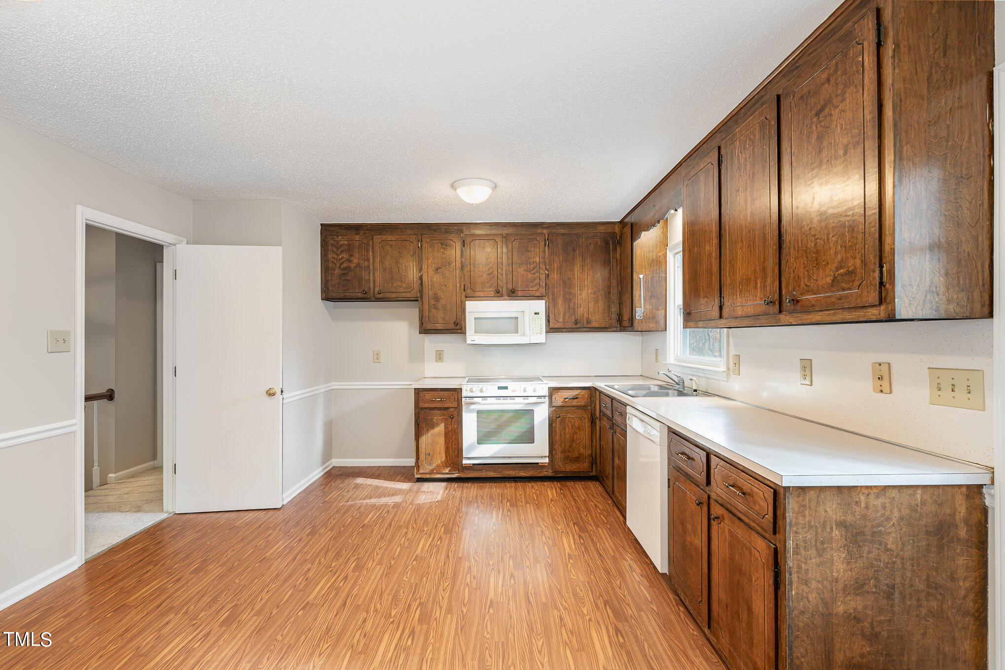 3703 Sandy Ridge Lane Durham, NC 27705 - Photo 12 of 36 a kitchen with stainless steel appliances granite countertop wooden cabinets a stove top oven a sink and dishwasher
