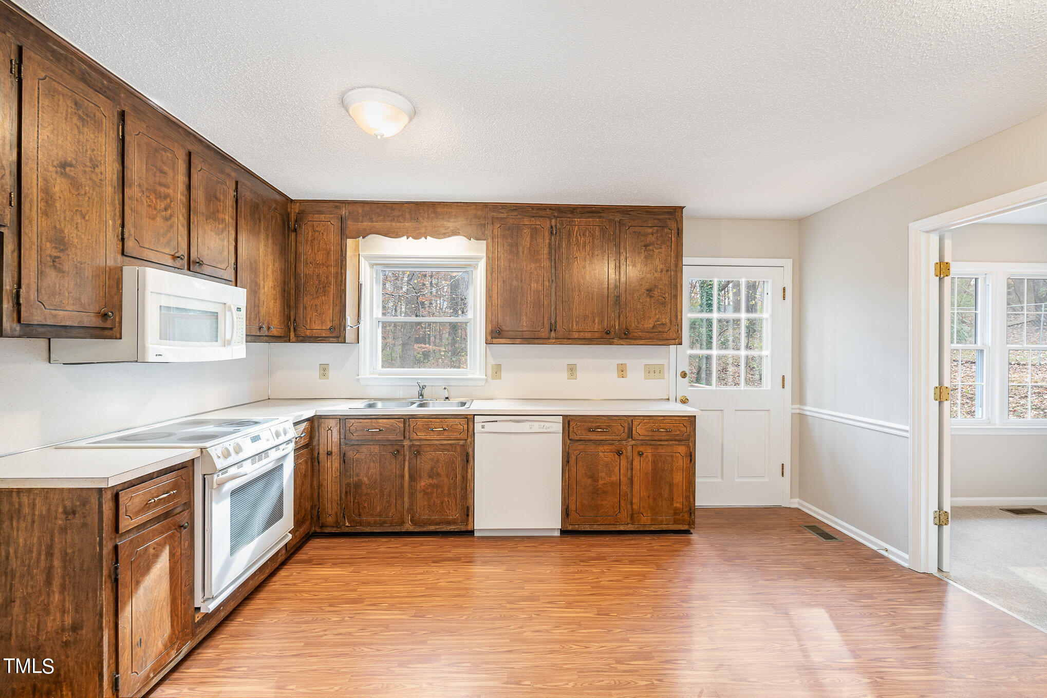 3703 Sandy Ridge Lane Durham, NC 27705 - Photo 14 of 36 a large kitchen with stainless steel appliances granite countertop a stove a sink and a refrigerator