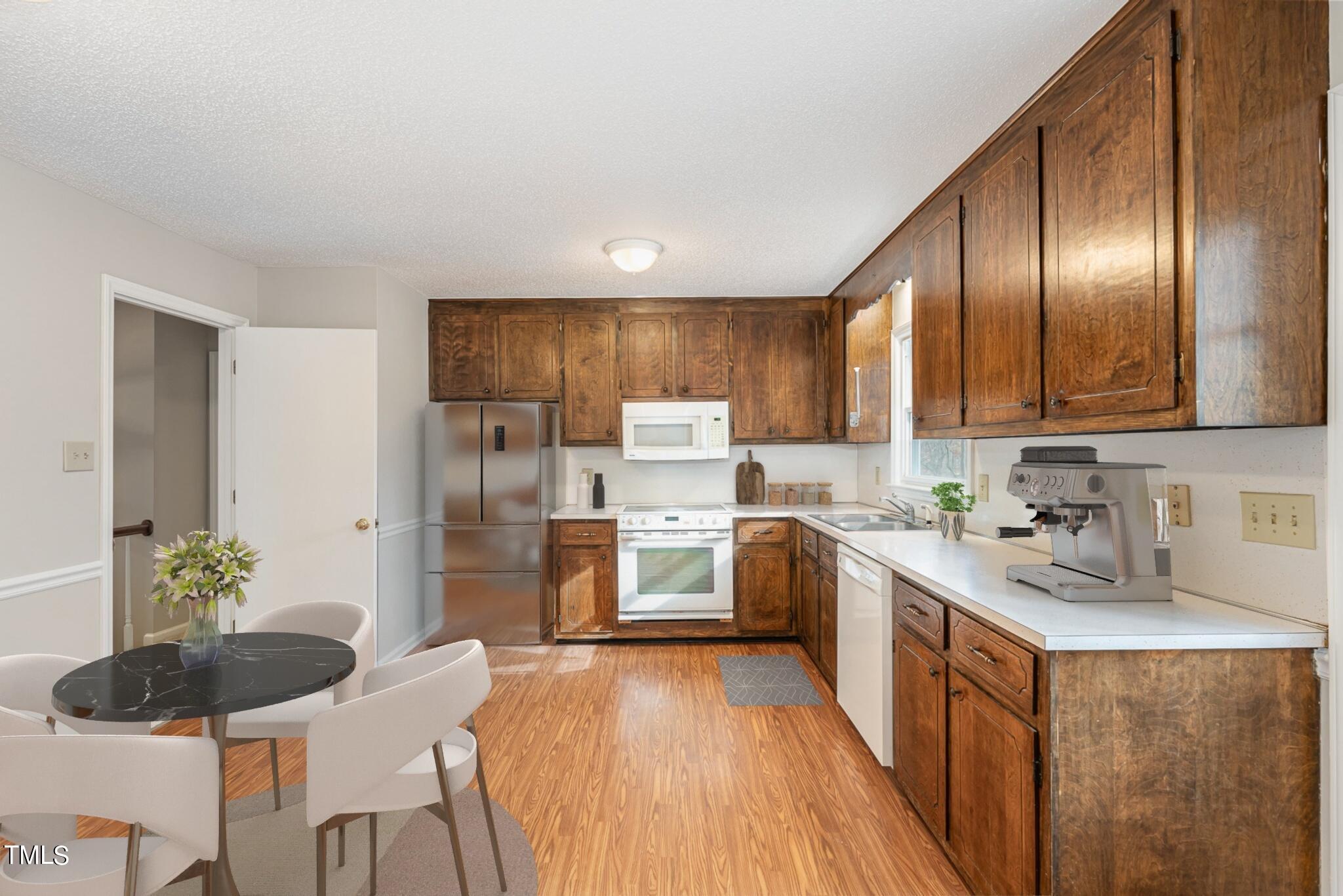 3703 Sandy Ridge Lane Durham, NC 27705 - Photo 15 of 36 a kitchen with granite countertop stainless steel appliances a refrigerator sink and cabinets