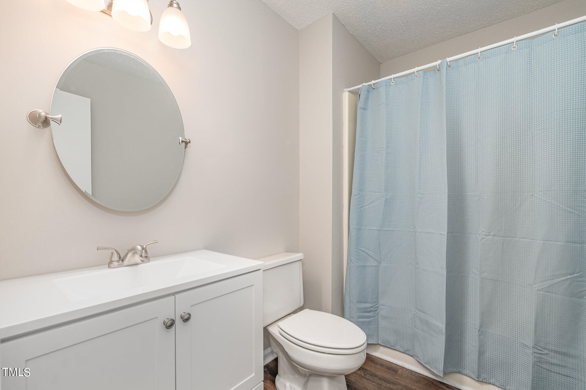 3703 Sandy Ridge Lane Durham, NC 27705 - Photo 25 of 36 a bathroom with a sink toilet and a mirror